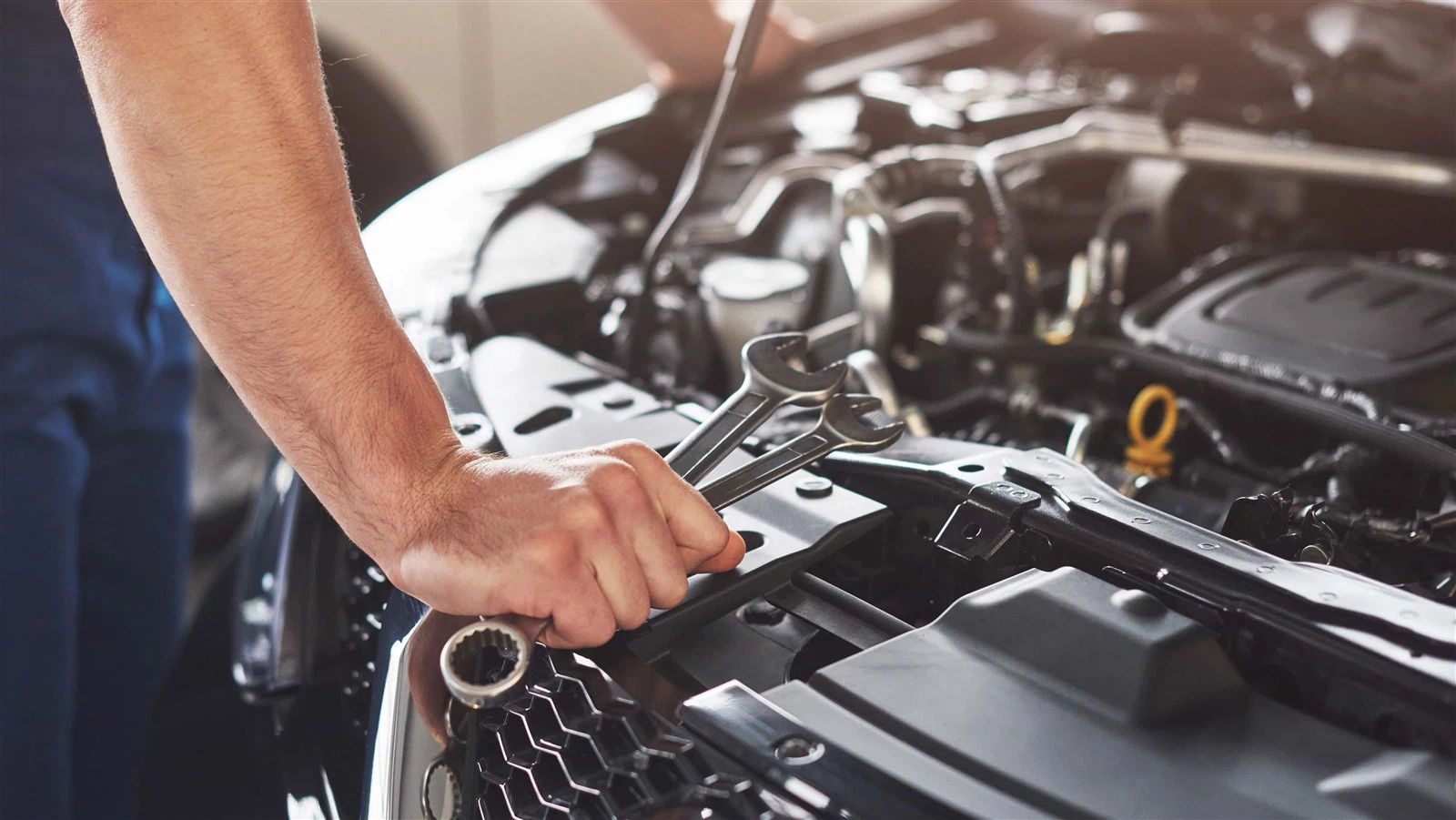 muscular-car-service-worker-repairing-vehicle muscular-car-service-worker-repairing-vehicle